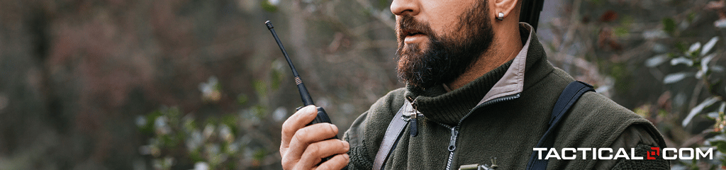 a man holding a satellite phone